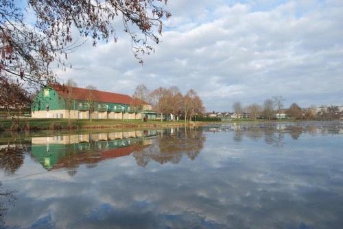 a building sitting next to a large body of water at ibis Styles Bourbon Lancy in Bourbon-Lancy