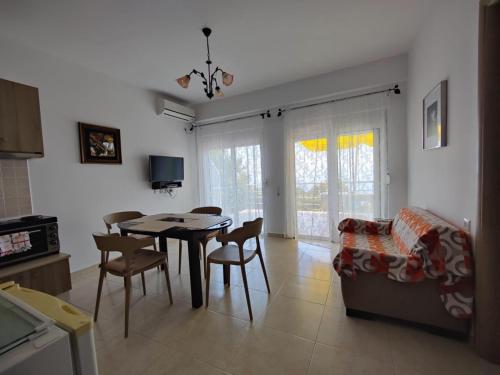 a kitchen and dining room with a table and chairs at Amazing View Apartments at Kroi i Gjine, Piqeras in Piqeras