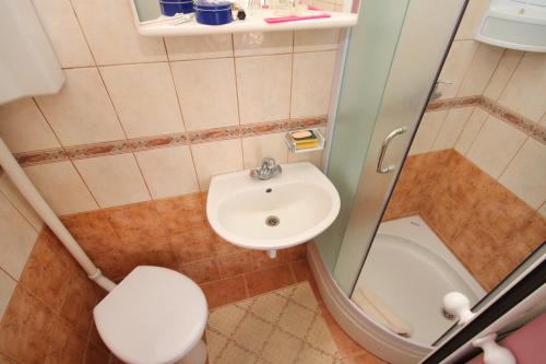 a small bathroom with a sink and a toilet at Double Room Palit 5061a in Rab