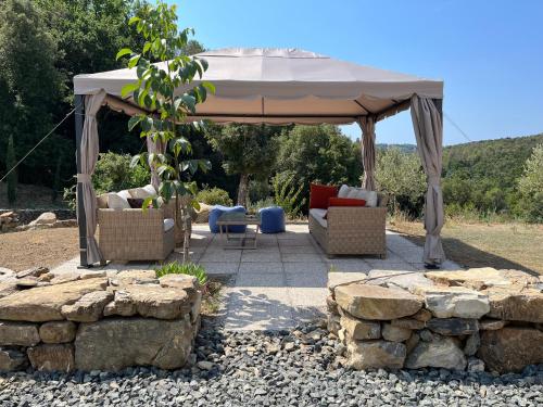 a gazebo with two couches and a table and chairs at b&b Tenuta il Molino in Quercianella