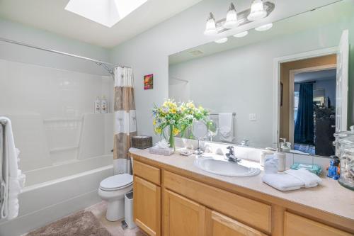 ein Badezimmer mit einem Waschbecken, einem WC und einem Spiegel in der Unterkunft Entire house with Four Bedrooms, Hot Tub, BBQ, Private Backyard, FREE WiFi and Parking, near Seattle, EV in Lynnwood