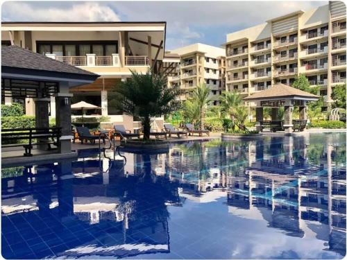 a swimming pool in front of a resort at MaRoy Suites at Asteria Residences (Near NAIA with free Parking+Fiber Internet) in Manila