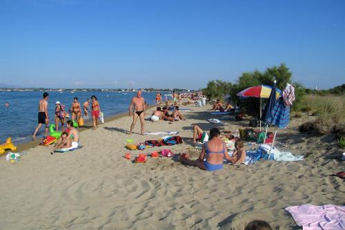 a group of people sitting on a beach at Apartments by the sea Nin, Zadar - 12890 in Nin