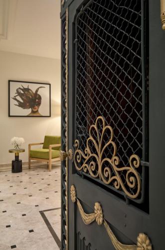 a door with a wrought iron gate in a living room at Hotel Saski Krakow Curio Collection by Hilton in Kraków