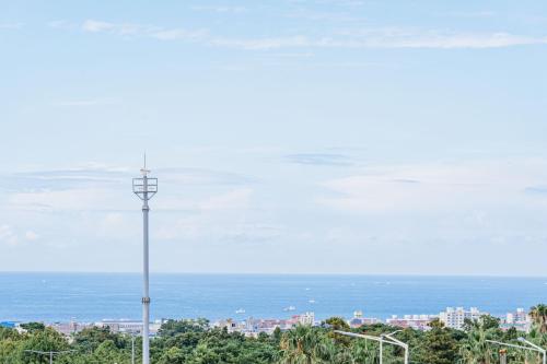 a street light with a view of the ocean at Jeju Miracle Hotel in Jeju