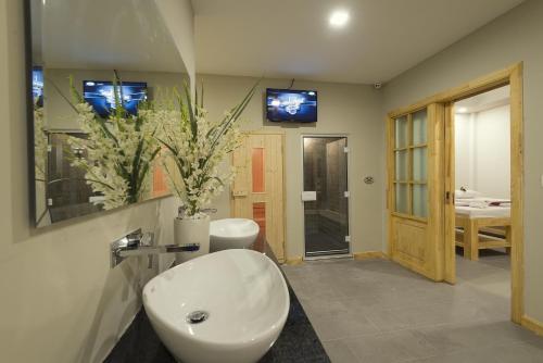 a bathroom with a white sink and a mirror at Anik Boutique Hotel in Phnom Penh