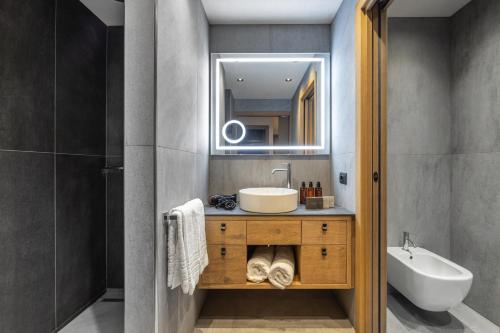a bathroom with a sink and a mirror at Hotel Nordik Adults Only - Over 14 in Andalo