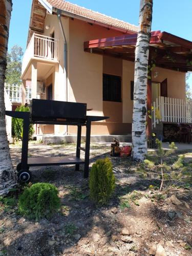 a picnic table in front of a house at Divčibarka in Divčibare