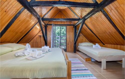 twee bedden in een kamer met houten wanden bij Lovely Home In Ogulin With Wifi in Ogulin
