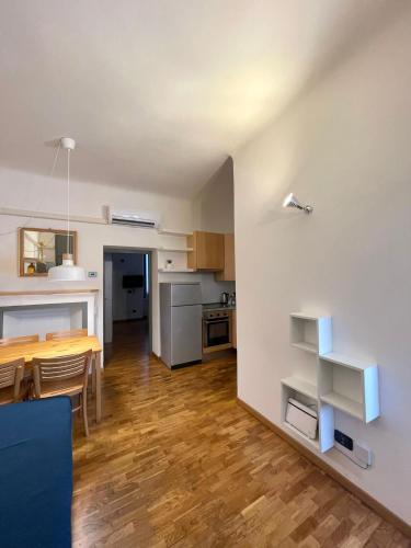 a kitchen and dining room with a table and a dining room at Easy Milano - Rooms and Apartments Navigli in Milan