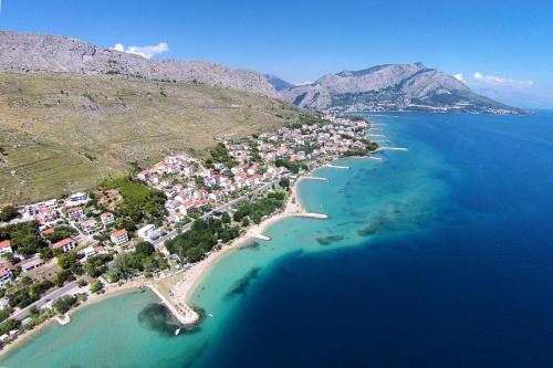 an aerial view of a small island in the ocean at Apartments and rooms by the sea Duce, Omis - 18155 in Omiš