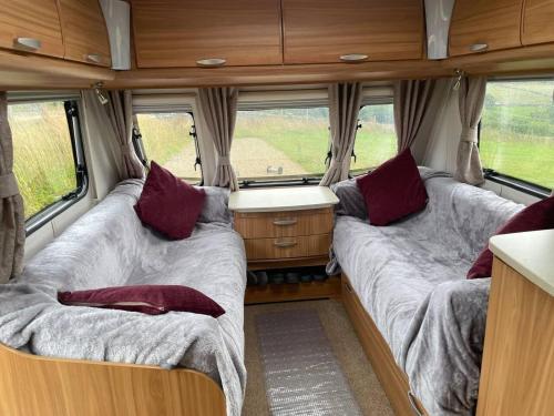 two beds in the rear of a camper van at Inviting 4 Berth caravan in Hebden Bridge in Halifax