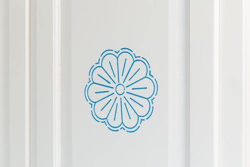 a drawing of a flower on a white wall at Sa Domm'e Galleria in Baunei