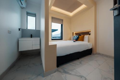 a bedroom with a large bed and a window at Cozy M Hostel in Sydney