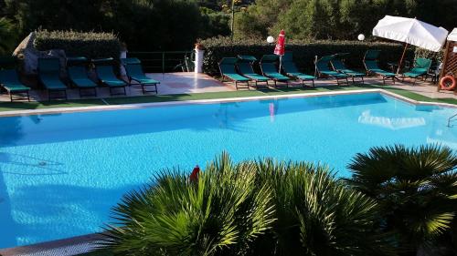 a swimming pool with lounge chairs and a swimming pool at Villa La Liccia Misia in Santa Teresa Gallura