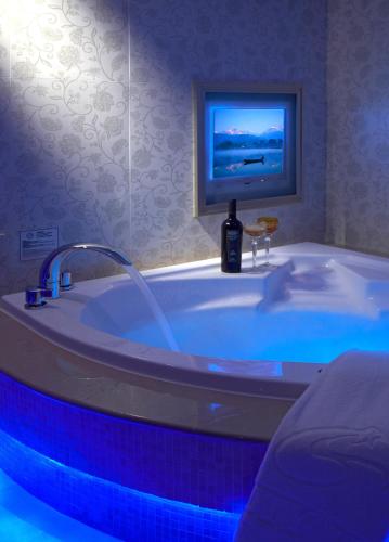a bathroom with a tub with a bottle of wine in it at Beauty Hotels - Roumei Boutique in Taipei