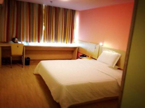 a bedroom with a white bed and a window at 7Days Inn Xi'an North Street Subway Station Lianhu Park in Xi'an
