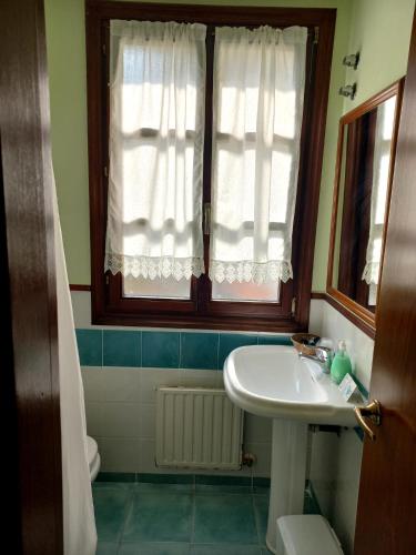 a bathroom with a sink and a window at Hotel Matsa B&B in Lezama