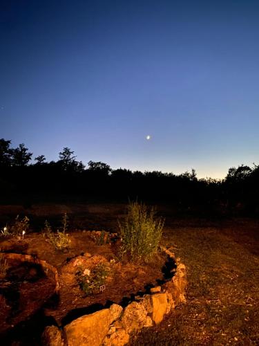 a view of a field with a rock formation at Agriturismo Monte Gusciani in Massa Marittima