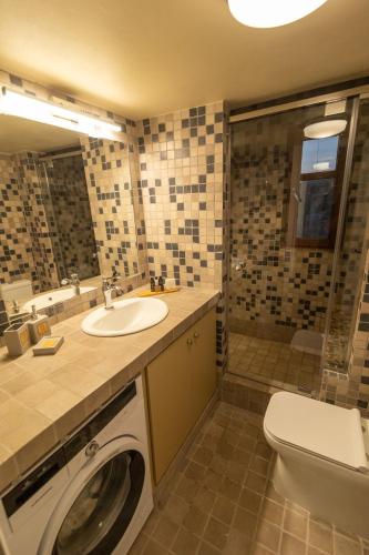 a bathroom with a sink and a washing machine at Harmony Seaview Villas In Elafonisos in Elafonisos