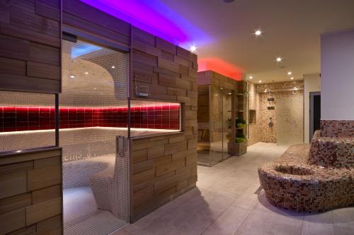 a lobby with a bar with a chair and a table at Flamingo Grand Hotel & Spa in Albena