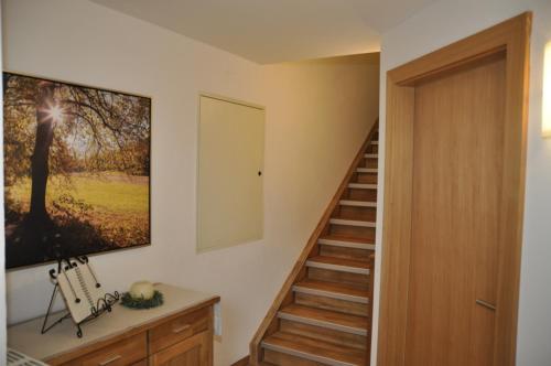 a staircase in a house with a painting on the wall at Flierelerhof in Arzl im Pitztal
