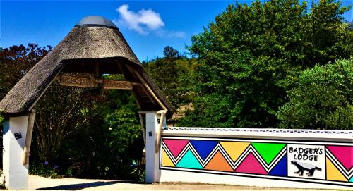 a gazebo with a turf roof on top of a fence at Badger's Lodge in Knysna