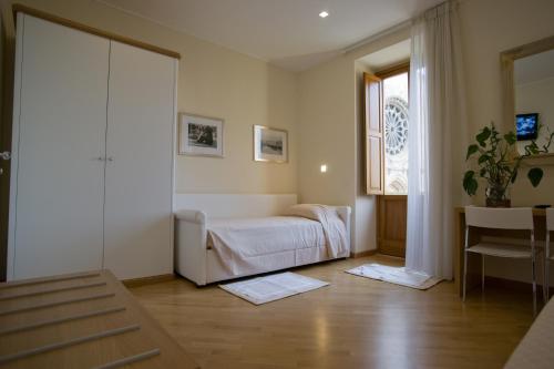 a living room with a bed and a window at La Locanda di Gino in Sulmona