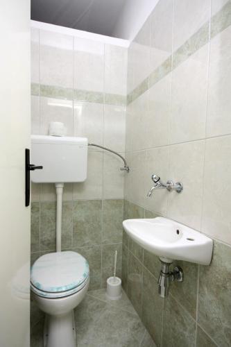 a bathroom with a toilet and a sink at Apartments with parking space Kampor, Rab - 4985 in Kampor