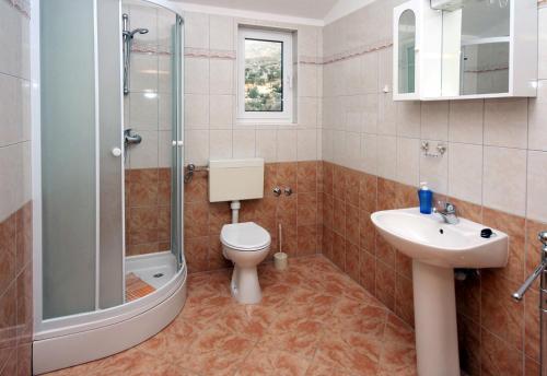 uma casa de banho com um WC, um lavatório e um chuveiro em Apartments with WiFi Seget Vranjica, Trogir - 4870 em Trogir