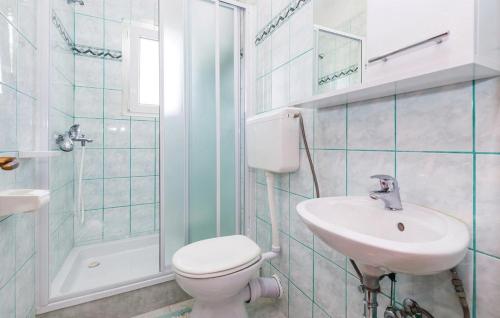 a bathroom with a toilet and a sink and a shower at Apartments with a parking space Palit, Rab - 4990 in Rab