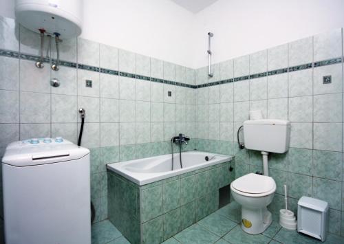un bagno con wc e vasca da bagno di Family-friendly apartments with swimming pool Barbat, Rab - 4988 a Rab
