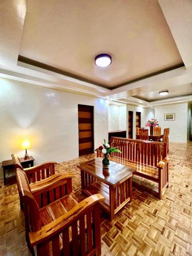 a restaurant with wooden chairs and a wooden table at Elliannah Pines Hotel in Baguio