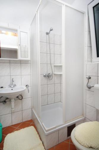 a bathroom with a shower and a sink at Apartments by the sea Barbat, Rab - 4993 in Barbat na Rabu