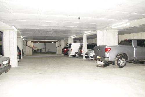 a parking garage with cars parked in it at Hotel Le Alpi in Livigno