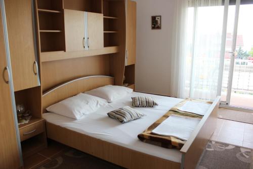 a bed in a small room with a window at Apartments by the sea Selce, Crikvenica - 4801 in Selce