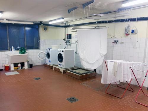a laundry room with two washers and a washing machine at Cervinia Sky & Ski in Breuil-Cervinia