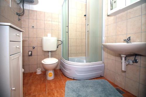 a bathroom with a toilet and a sink at Apartments by the sea Tisno, Murter - 5136 in Tisno