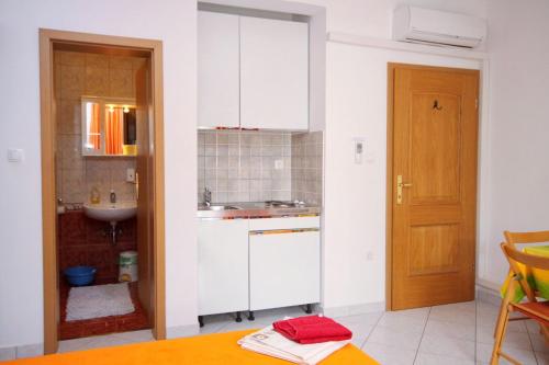 a kitchen with a sink and a counter top at Apartments by the sea Selce, Crikvenica - 5206 in Selce