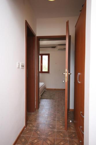 a hallway with a door open to a bedroom at Apartments by the sea Mandre, Pag - 6474 in Mandre