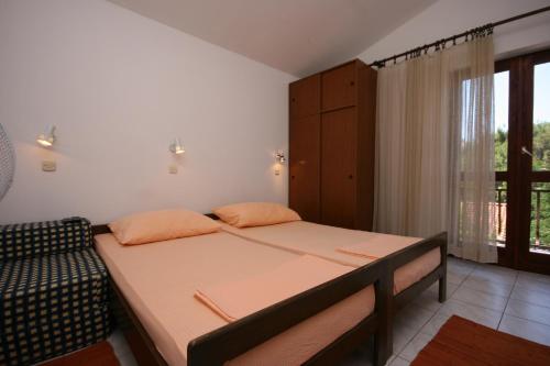 a small bedroom with a bed and a window at Apartments by the sea Zaostrog, Makarska - 6799 in Podaca