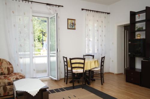 a living room with a table and chairs at Apartments by the sea Podgora, Makarska - 6764 in Podgora