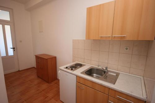 a kitchen with a sink and a counter top at Apartments with a parking space Gradac, Makarska - 6724 in Gradac