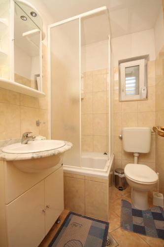 a bathroom with a sink and a toilet and a shower at Apartments with parking space Baska Voda, Makarska - 6854 in Baška Voda
