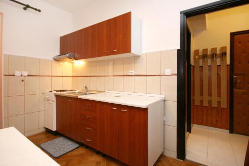 małą kuchnię ze zlewem i kuchenką w obiekcie Apartments by the sea Pag - 6448 w mieście Pag