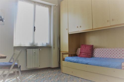 um quarto com uma cama, uma secretária e uma cadeira em Appartamento Il Porticciolo em Marina dʼAndora