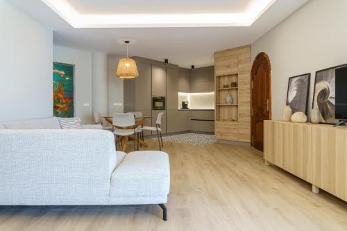 a living room with a white couch and a table at LUXURY APARTMENT Benalmadena Costa in Benalmádena