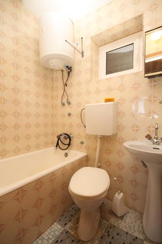 a bathroom with a toilet and a sink at Apartments and rooms by the sea Baska Voda, Makarska - 6748 in Baška Voda