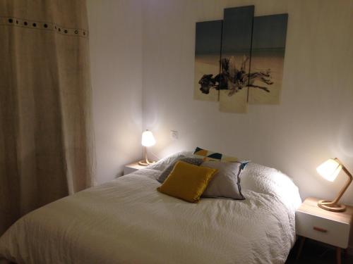 - une chambre avec un lit blanc et 2 lampes sur les tables dans l'établissement BIDART CENTRE et PLAGE A PIED, à Bidart