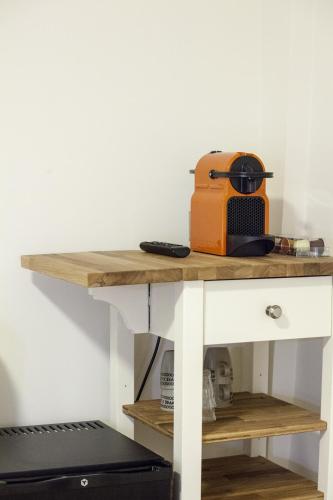 a table with a toaster on top of it at Kuwadro Guesthouse Jordaan in Amsterdam